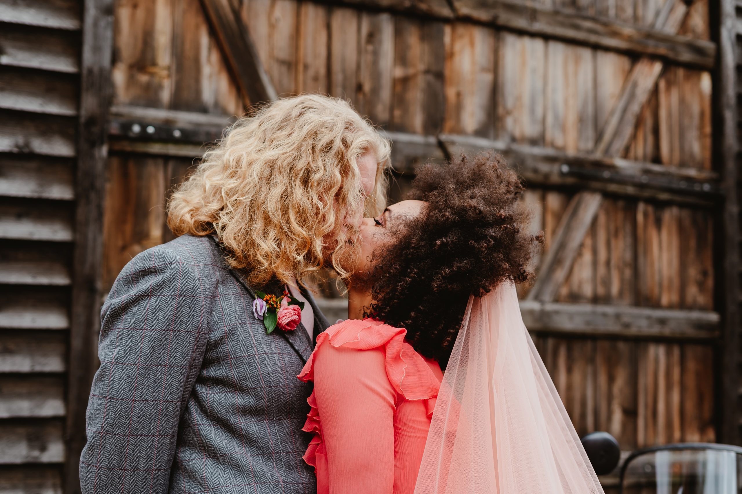 Couples kissing, Alt wedding in Essex in front of a barn